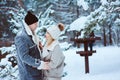 Winter portrait of happy romantic couple embracing and looking to each other outdoor in snowy day Royalty Free Stock Photo