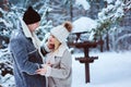 Winter portrait of happy romantic couple embracing and looking to each other outdoor in snowy day Royalty Free Stock Photo