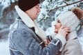 winter portrait of happy romantic couple enjoying their walk in snowy forest or park Royalty Free Stock Photo