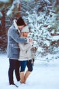 winter portrait of happy romantic couple warm up each other on the walk in snowy forest Royalty Free Stock Photo