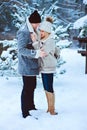 winter portrait of happy romantic couple warm up each other on the walk in snowy forest Royalty Free Stock Photo