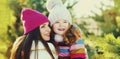 Winter happy smiling mother and little girl child playing outdoors on snowy background Royalty Free Stock Photo