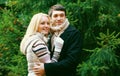 Winter portrait happy smiling young couple looking away outdoors on christmas tree background Royalty Free Stock Photo