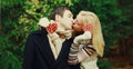 Winter portrait happy young kissing couple in love outdoors on christmas tree background Royalty Free Stock Photo