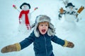 Winter portrait of little boy child in snow Garden make snowman. Child playing with Snowman on snow background. Winter Royalty Free Stock Photo