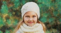 Winter portrait of little girl child wearing knitted hat sweater and scarf near christmas tree Royalty Free Stock Photo