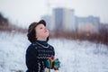 Winter portrait of little kid boy wearing a knitted sweater with deers, outdoors during snowfall. Royalty Free Stock Photo
