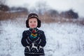 Winter portrait of little kid boy wearing a knitted sweater with Royalty Free Stock Photo