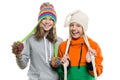 Winter portrait of two happy smiling pretty girls in knitted hats having fun, isolated on white background, people, youth and frie Royalty Free Stock Photo