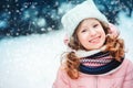 Winter portrait of 8 years old kid girl walking outdoor in snowy day