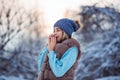 Winter portrait of young beautiful woman wearing warm clothes. Snowing winter beauty fashion concept