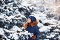 Winter portrait: Young pretty girl dressed in a warm woolen clothes, scarf and covered head posing outside. Royalty Free Stock Photo