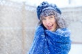 Winter portrait of a young woman. Beauty Joyous Model Girl touching her face skin and laughing, having fun in the winter park. Bea Royalty Free Stock Photo