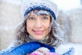 Winter portrait of a young woman. Beauty Joyous Model Girl touching her face skin and laughing, having fun in the winter park. Bea Royalty Free Stock Photo