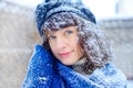 Winter portrait of a young woman. Beauty Joyous Model Girl touching her face skin and laughing, having fun in the winter park. Bea Royalty Free Stock Photo