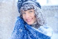 Winter portrait of a young woman. Beauty Joyous Model Girl touching her face skin and laughing, having fun in the winter park. Bea Royalty Free Stock Photo