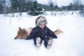 Winter portrtrait of baby and dog Royalty Free Stock Photo