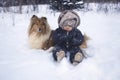 Winter portrtrait of baby and dog Royalty Free Stock Photo
