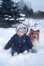 Winter portrtrait of baby and dog Royalty Free Stock Photo