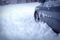 Winter problems of car drivers. Frozen car covered snow at winter night