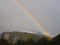 Winter rainbow in the forest and snowy mountains Dirfys on the island of Evia in Greece