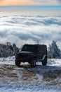 Winter ravel concept with 4x4 car. Offroad winter car. Adventure travel. Off-road travel on snow mountain road.
