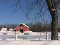 Winter: red barn with tree in snow Royalty Free Stock Photo