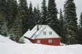 Winter red brick made house cabin snow covered trees in the pine wood Royalty Free Stock Photo