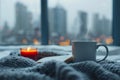 Winter relaxation coffee, candle, book set against city skyline