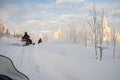 A winter ride on a snowmobiles, winter landscape and snowmobile track