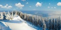 Winter rime and snow covered hill top with fir trees and  snowdrifts Carpathian Mountains, Ukraine Royalty Free Stock Photo