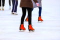 Winter rink. The girl in the red skates riding on the ice. Active family sport during the children s holidays and the cold season Royalty Free Stock Photo