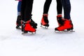 Winter rink. The girls in the red skates riding on the ice. Active family sport during the children s holidays and the cold season Royalty Free Stock Photo