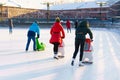 Winter rink. Girls on skates ride on ice. Active family sport during kids Royalty Free Stock Photo