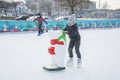 In winter  on the rink  a little girl learns to skate Royalty Free Stock Photo