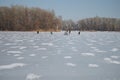 Fishermen catch fish on ice fishing in winter. Dnepr River. Royalty Free Stock Photo