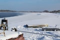 Winter landscape of the river Bank where the pier boats. Royalty Free Stock Photo