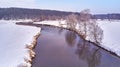 Winter river landscape, snow covered fields. Hoarfrost on trees, plants. Frosty morning. Sunny cloudy Misty weather. Cold season. Royalty Free Stock Photo