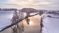 Winter river landscape, snow covered fields. Hoarfrost on trees, plants. Frosty morning. Sunny cloudy Misty weather. Cold season. Royalty Free Stock Photo