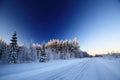 Winter road and blue sky with strong polarization filter effect Royalty Free Stock Photo