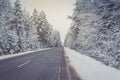 Winter on the road through coniferous forest. Beautiful winter scenery with on the road through  forest full of trees covered snow Royalty Free Stock Photo