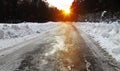 Winter road and forest at sunset Royalty Free Stock Photo