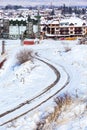 Winter road, houses with snow roofs panorama in bulgarian ski resort Bansko Royalty Free Stock Photo