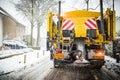 Winter road maintenance truck spreading salt and sand