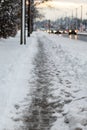 Winter road with melting from salt snow. Close up of sidewalk with slush on snowy day Royalty Free Stock Photo