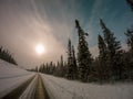 Winter road and pine trees with in Northern Sweden, Swedish nature landscape, view from driving car Royalty Free Stock Photo