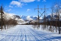 Winter road in the polar mountains and old electricity pillars Royalty Free Stock Photo