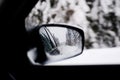 Winter road reflected in car rearview mirror Royalty Free Stock Photo