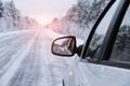 Winter road is reflected in the car`s mirror Royalty Free Stock Photo