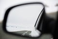 The winter road is reflected in the rear-view mirror Royalty Free Stock Photo